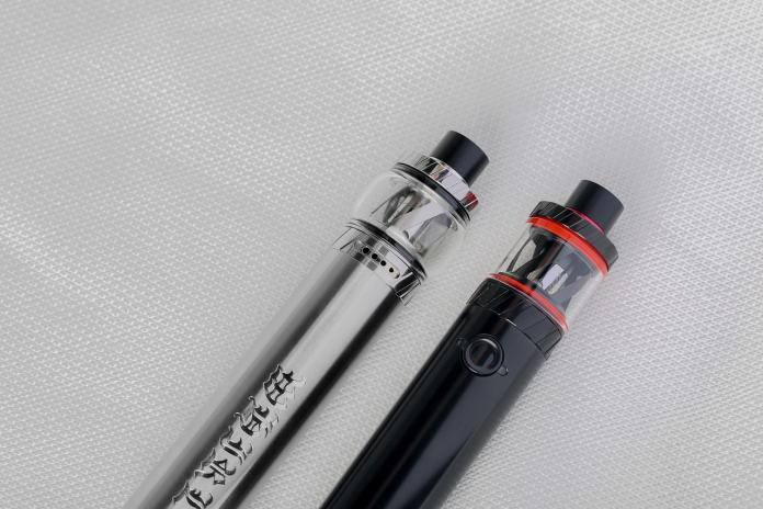 two vape pens black and silver on a white background