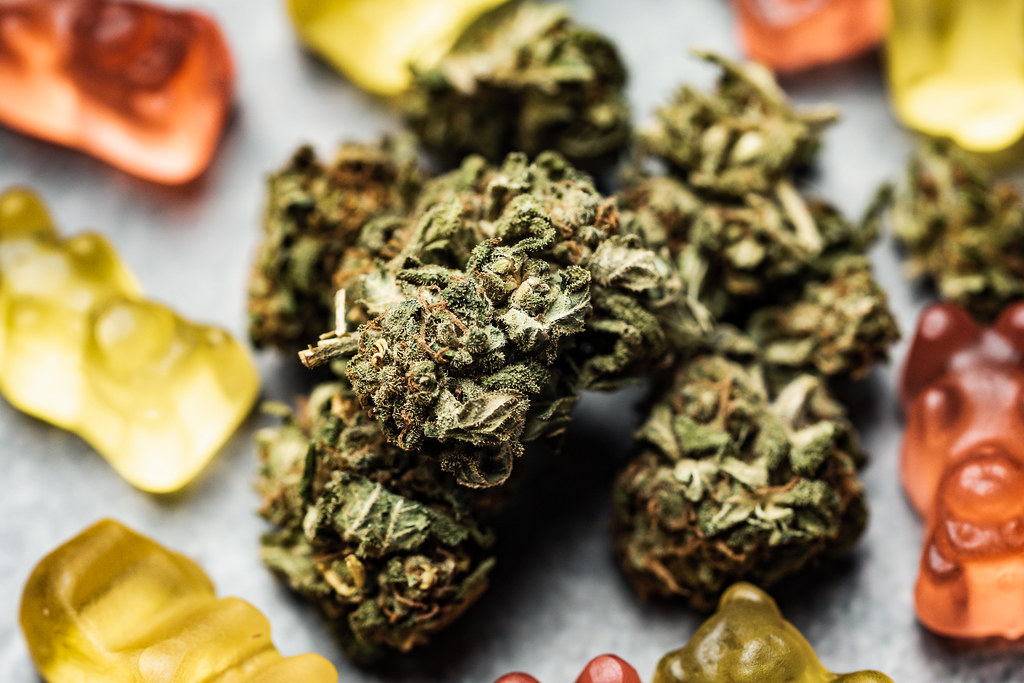 Dried cannabis buds mixed with colorful gummy bears